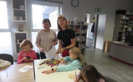 dwie penie bibliotekarki i dzieci, podczas zajęć w bibliotece, które odbyły się w ferie