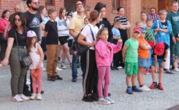 stoi grupa osób na dziedzińcu działdowskiego zamku