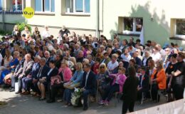 grupa osób siedzi przed budynkiem PSONI Koło w Działdowie, podczas obchodów jubileuszu